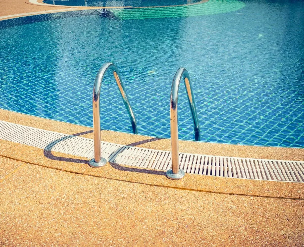 Swimming pool with stairs maintained by Freedom Pool Service in Concord NC